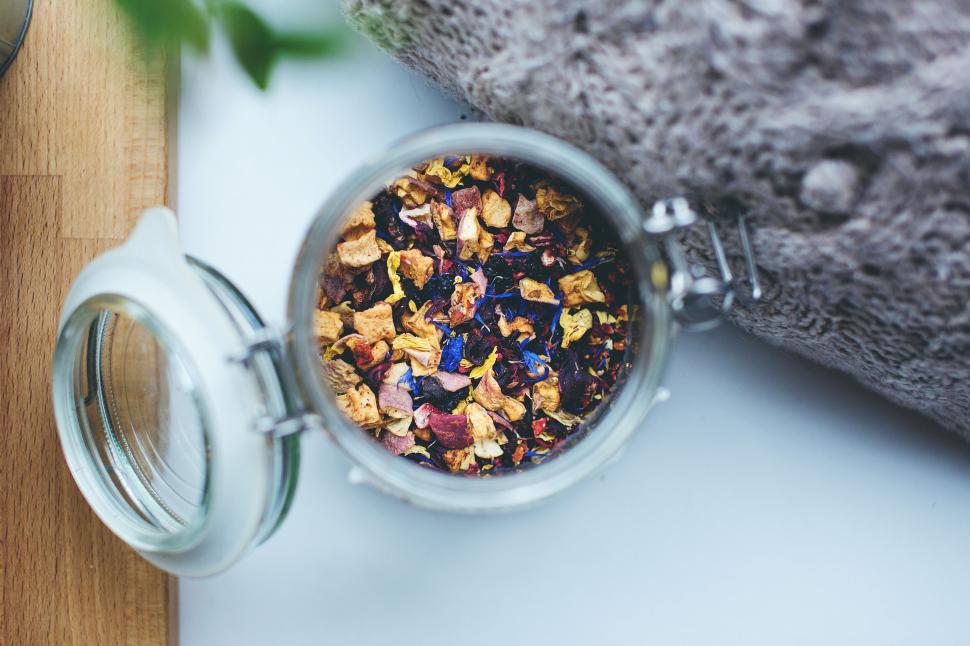 Free Image of Glass jar of dried flower tea on table 