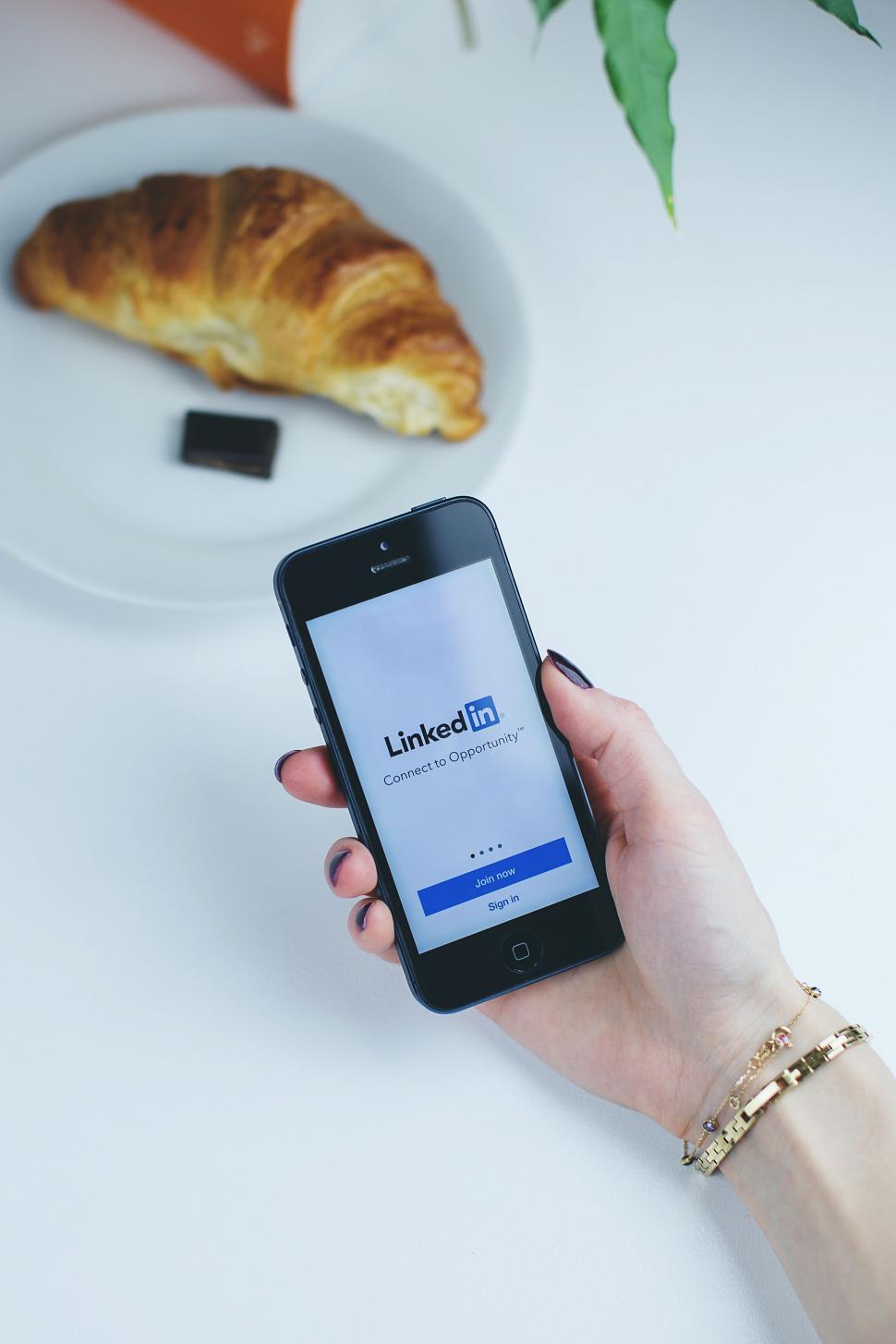 Free Image of Hand holding smartphone with LinkedIn on screen 
