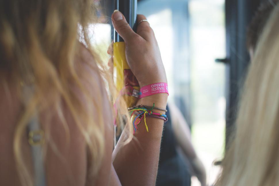Free Image of Hand wearing festival wristbands 