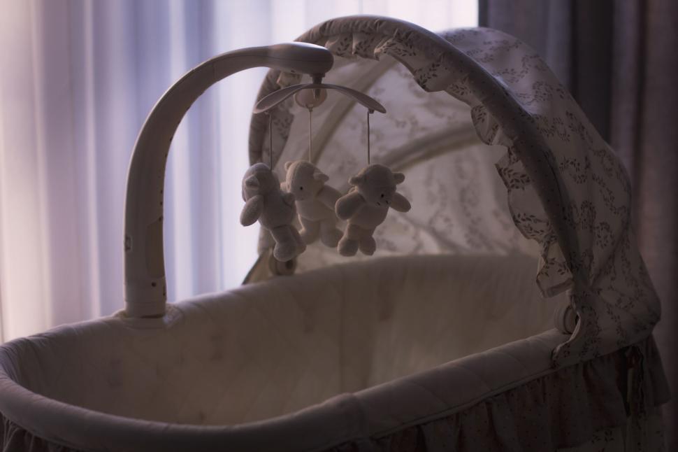 Free Image of Empty Baby Crib in Soft Evening Light 