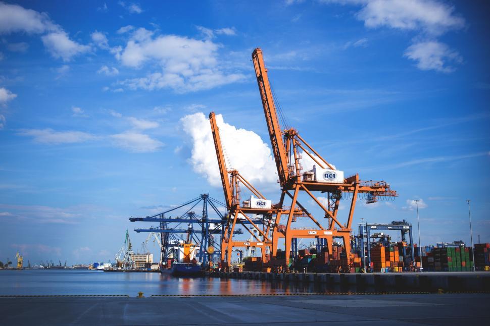 Free Image of Port cranes and containers against a blue sky 