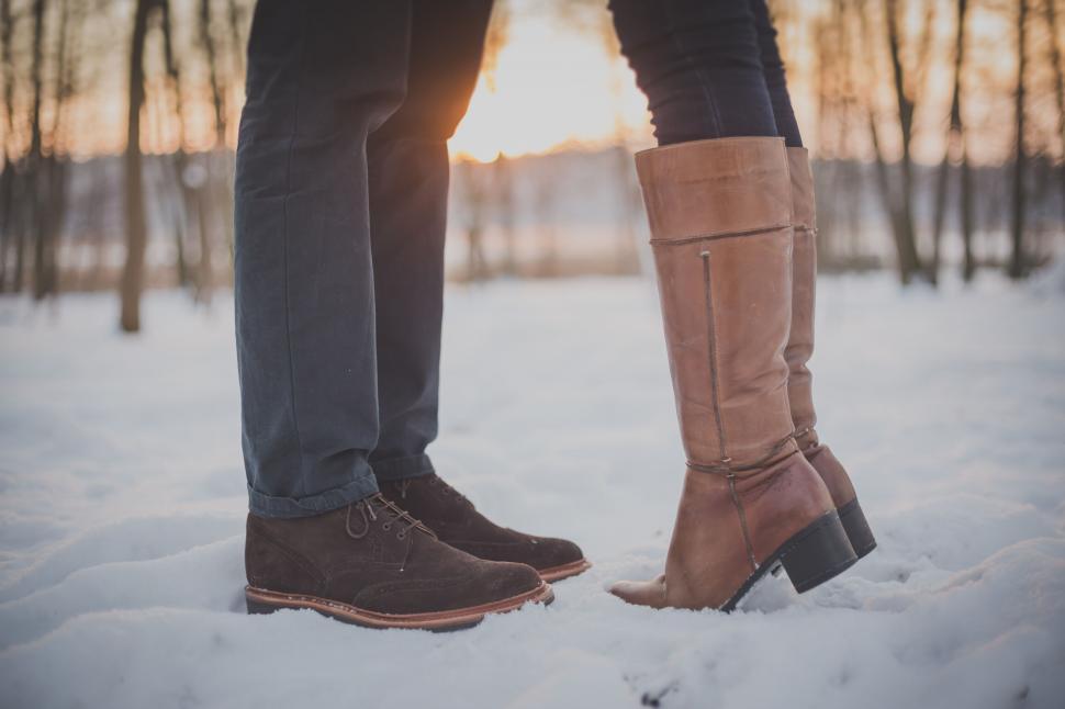 Free Image of Couple standing in snow at sunset 