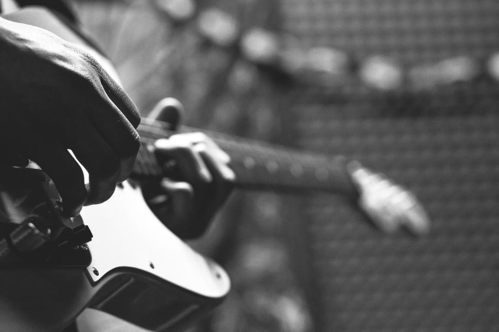 Free Image of Guitarist tuning electric guitar close-up 