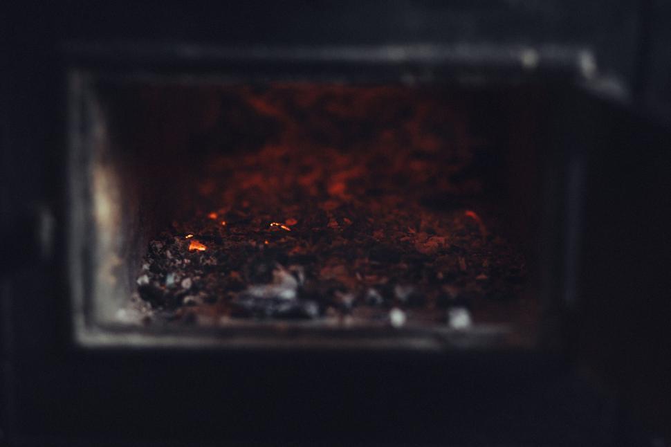 Free Image of Glowing embers in a dark fireplace 