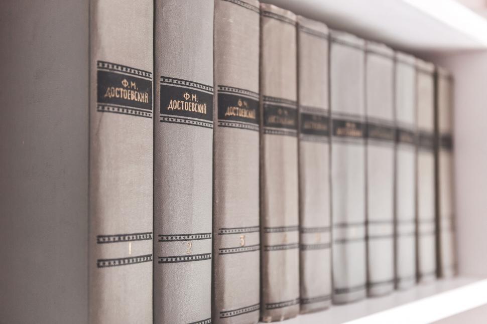 Free Image of Vintage books on a shelf in soft focus 
