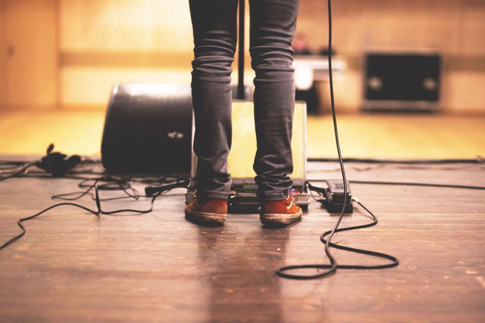 Free Image of Musician s feet on stage with cables 
