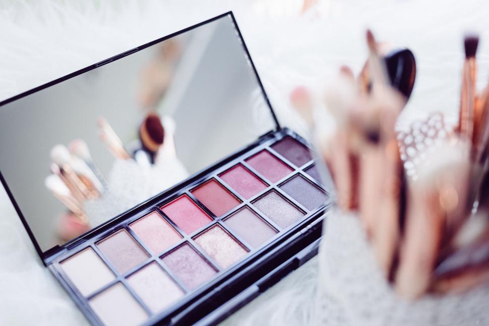 Free Image of Makeup palette and brushes in soft focus 