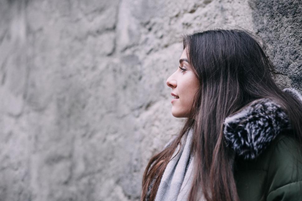 Free Image of Young woman gazing thoughtfully outdoors 
