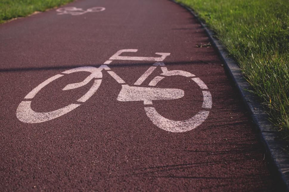 Free Image of Bicycle lane symbol on a red pathway 