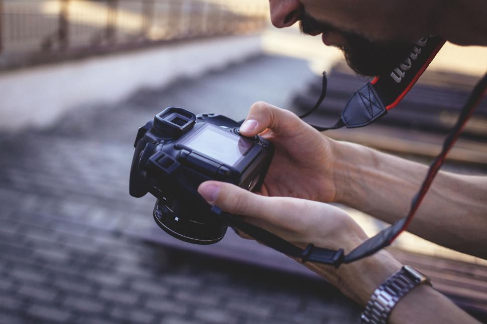 Free Image of Photographer reviewing images on a camera 