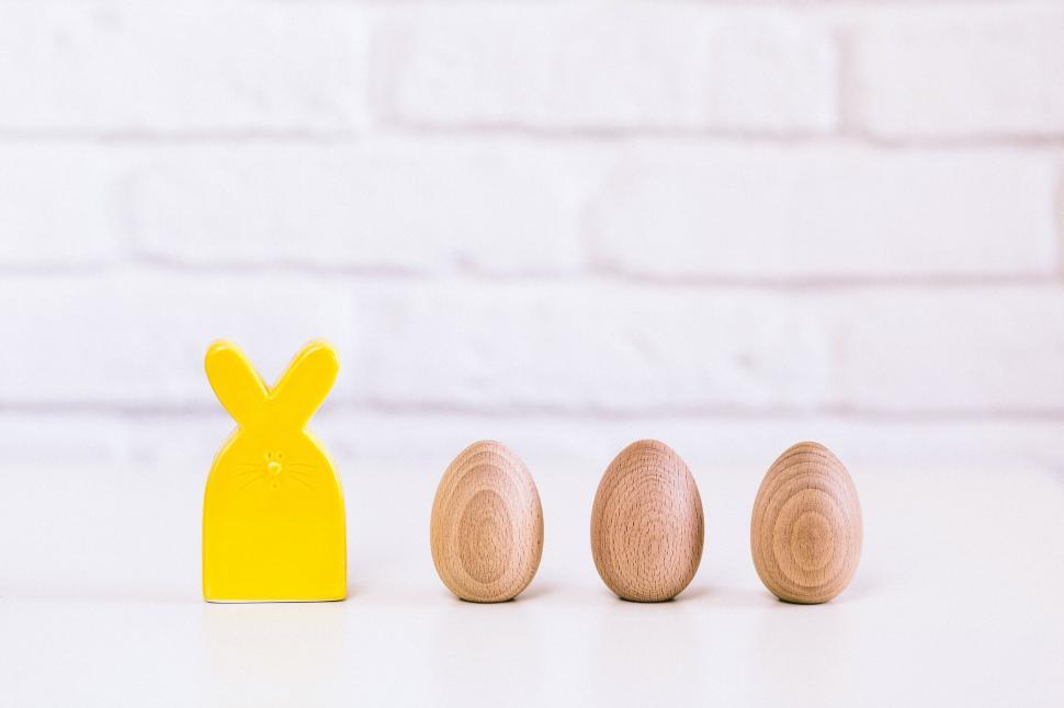 Free Image of Minimalistic setup with a yellow rabbit figure 