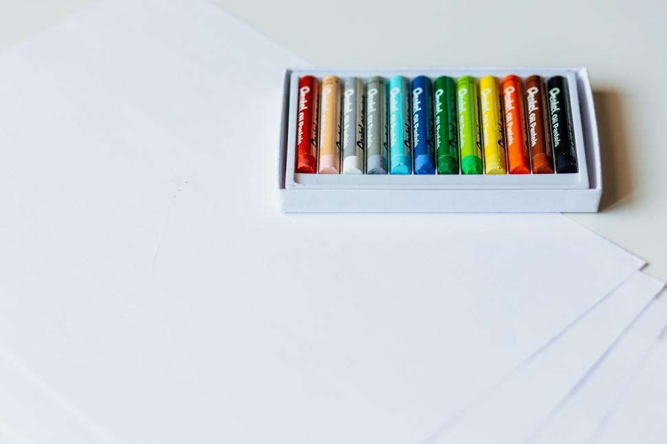 Free Image of Box of colorful crayons on white paper 