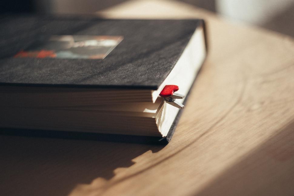 Free Image of Red bookmark in a closed book 