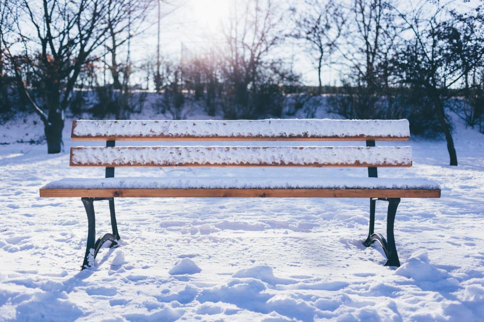 Free Image of Snow-covered park bench in daylight 