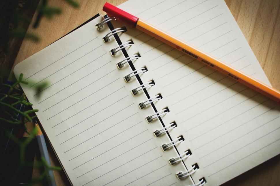 Free Image of Notebook and pencil on a wooden desk 