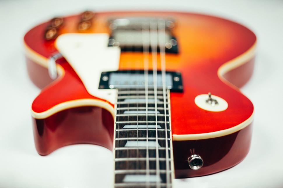 Free Image of Close up of a red electric guitar s body 