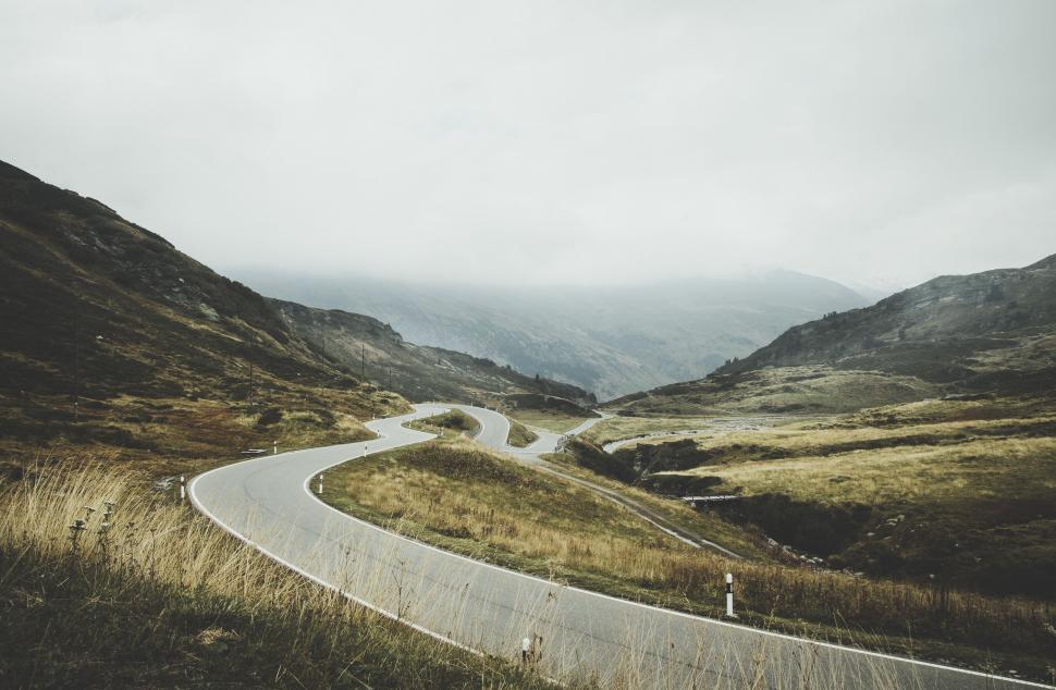 Free Image of Winding road through mountains in fog 