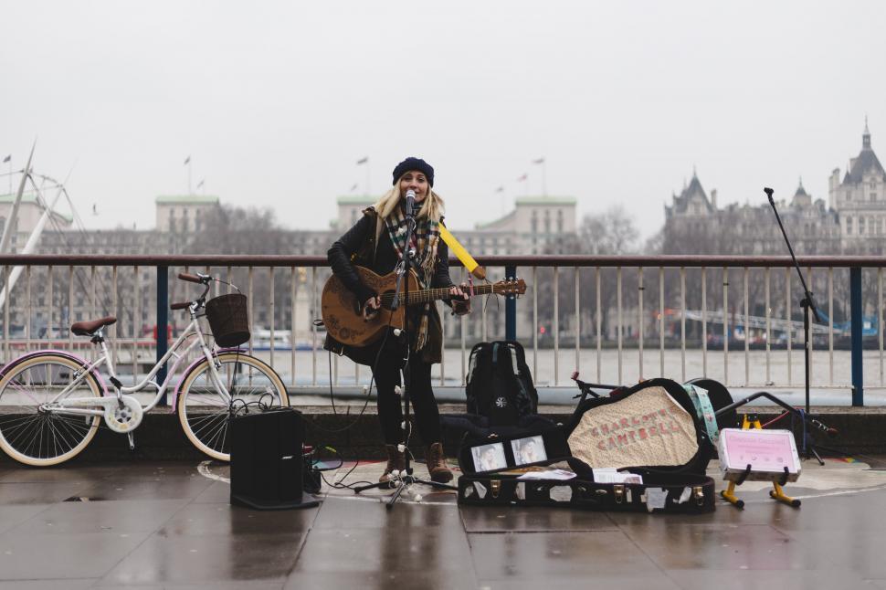Free Image of Street musician performing on a bridge 