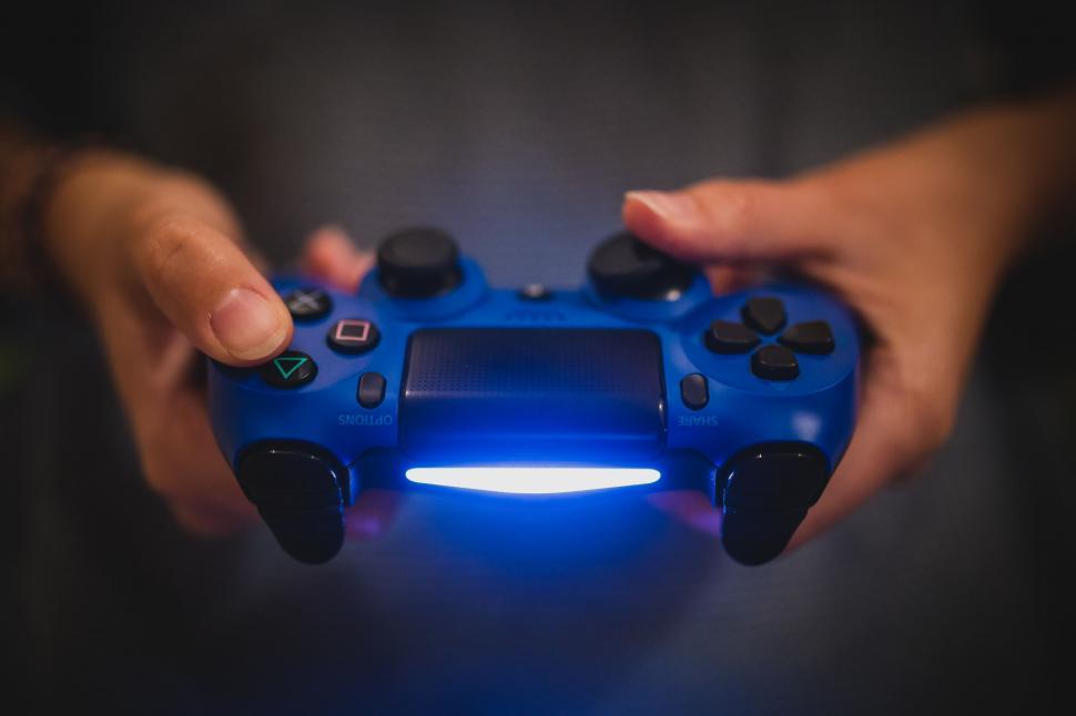 Free Image of Close-up of hands holding a game controller 