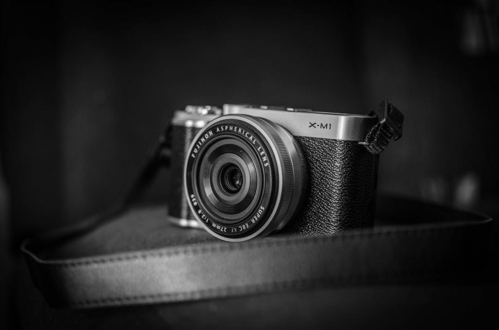 Free Image of Fujifilm X-M1 camera on black backdrop 