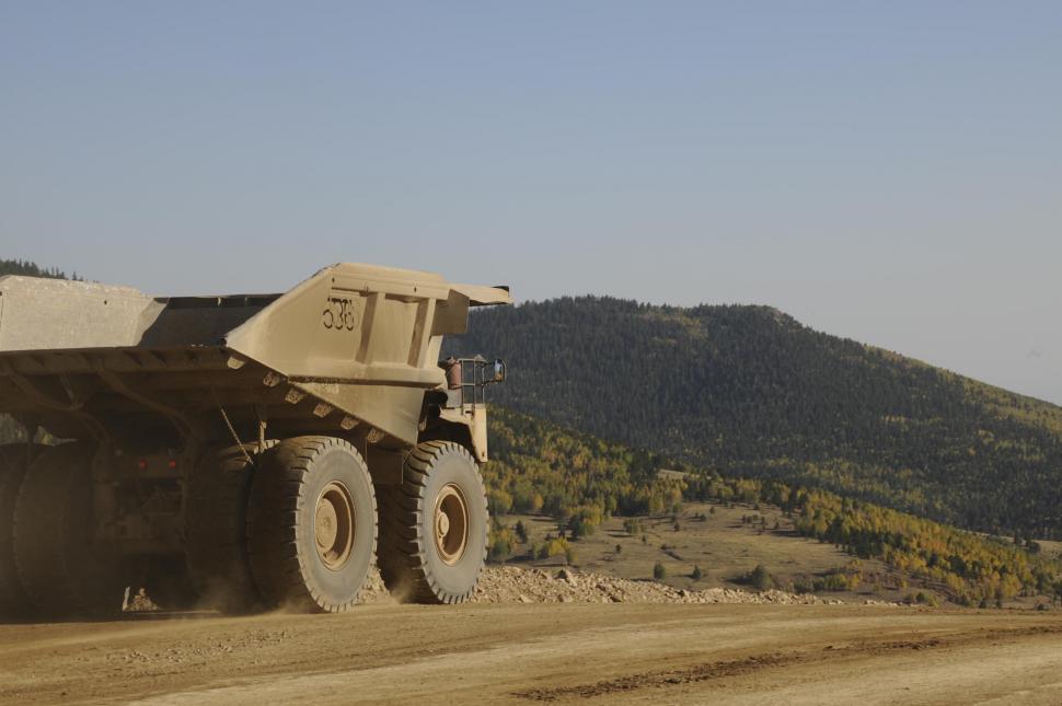 Free Image of Mining dump truck with green mountain in the background  