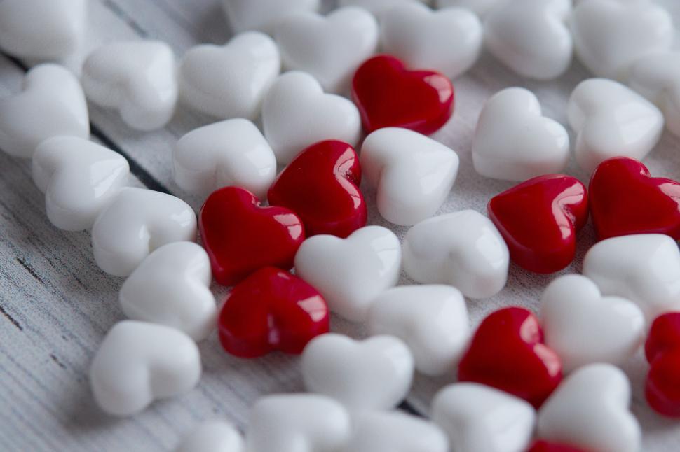 Free Image of Red and White Candy Hearts on Wooden Surface 