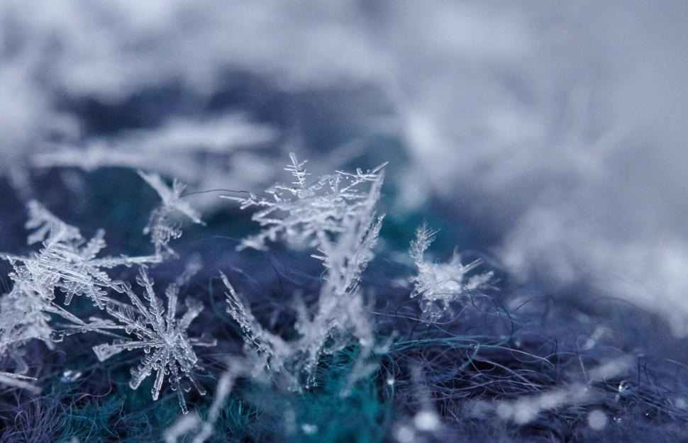 Free Image of Intricate Snowflakes on Blue Fiber Texture 