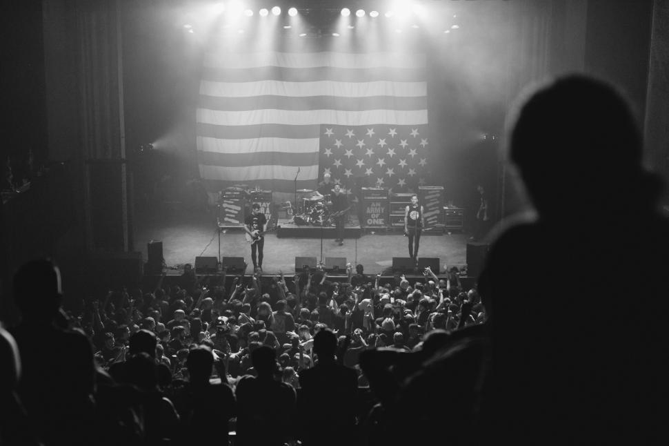 Free Image of Concert crowd scene with American flag backdrop 