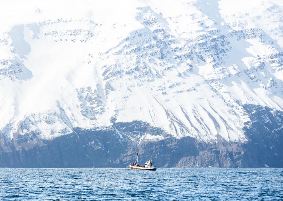 Free Image of Lone fishing boat in snowy mountain landscape 