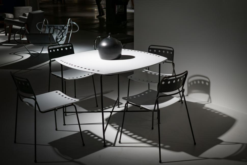 Free Image of Modern chairs around a minimalist dinner table 