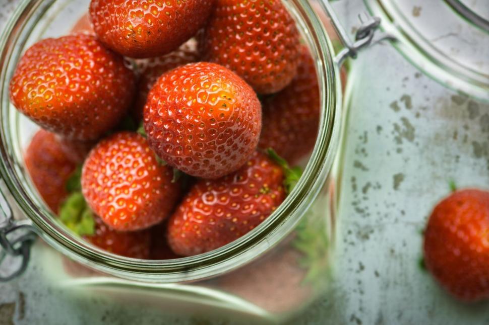 Free Image of Plump strawberries in a glass jar from above 