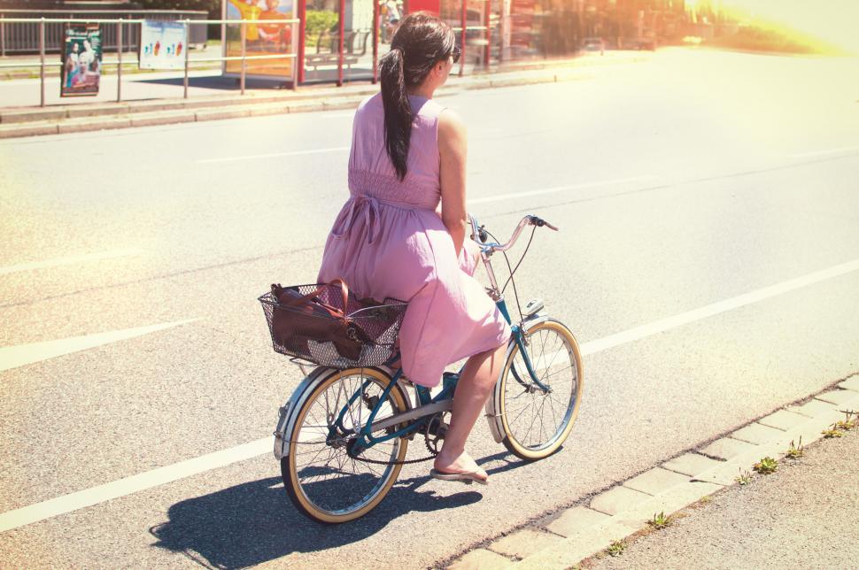 Free Image of Woman riding a bicycle in city park 