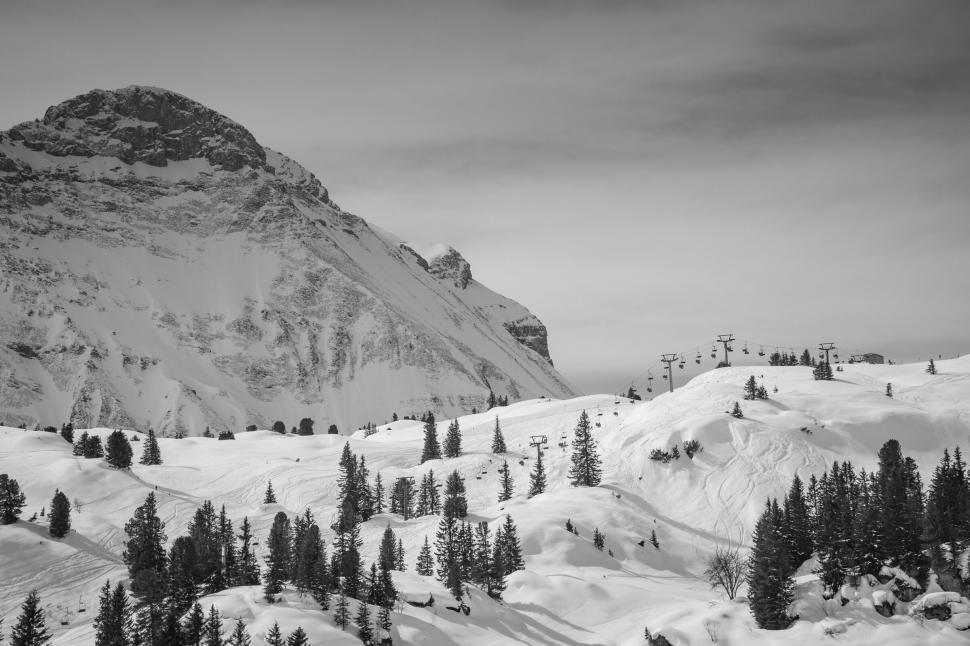 Free Image of Majestic snow-covered mountain with ski slopes 