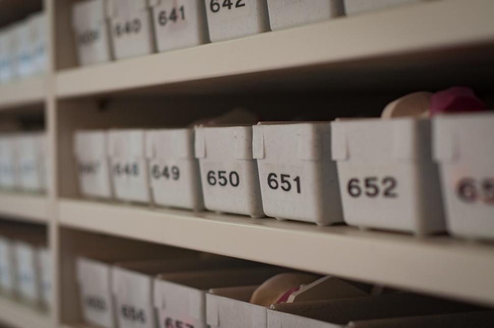 Free Image of Rows of archive boxes on shelves in a library 