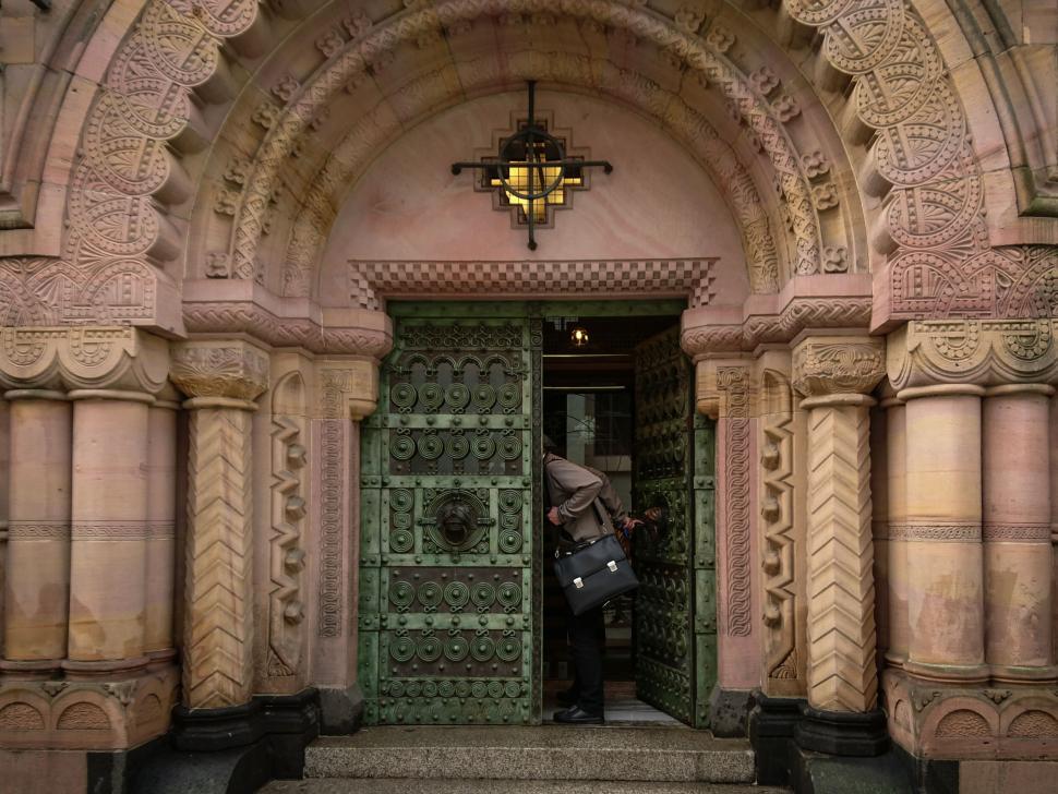 Free Image of Person Entering Ornate Cathedral Entrance 