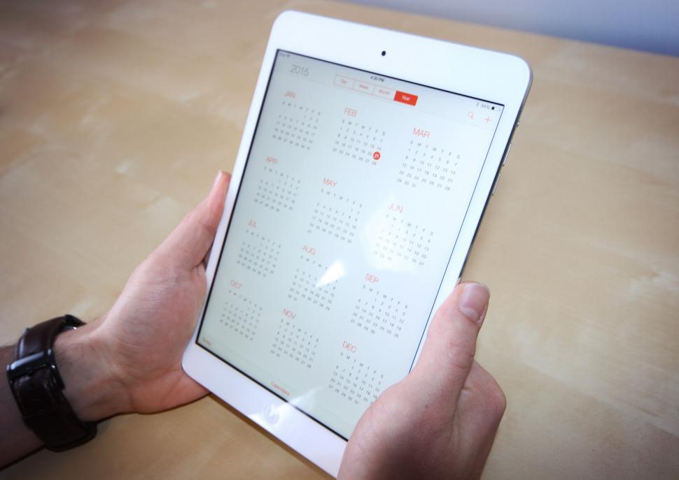 Free Image of Person holding tablet displaying calendar 