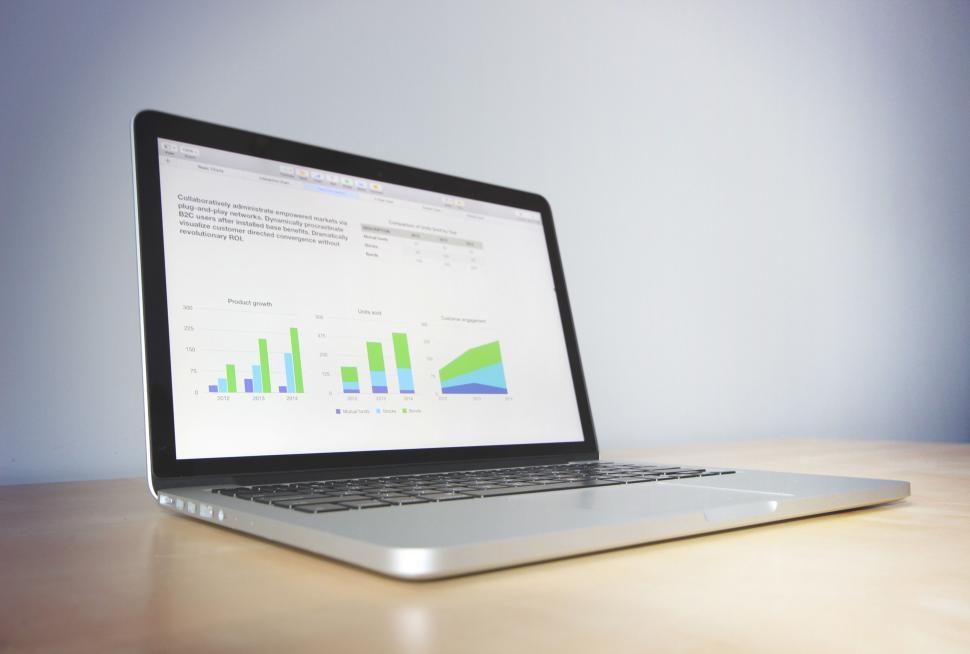 Free Image of Laptop with graphs and charts on screen 