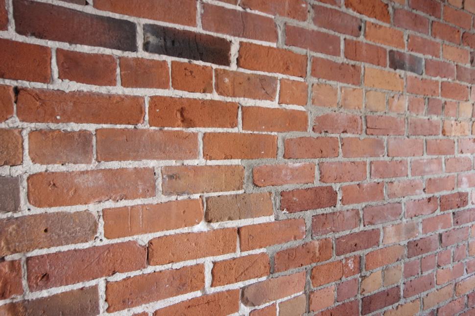 Free Image of Old brick wall with varying shades of red bricks 