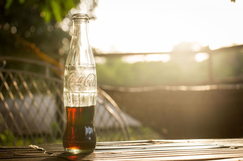 Free Image of Empty Coca-Cola bottle in the sunlight 