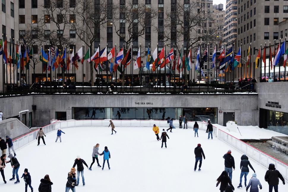 Free Image of Skating rink with people and flags 