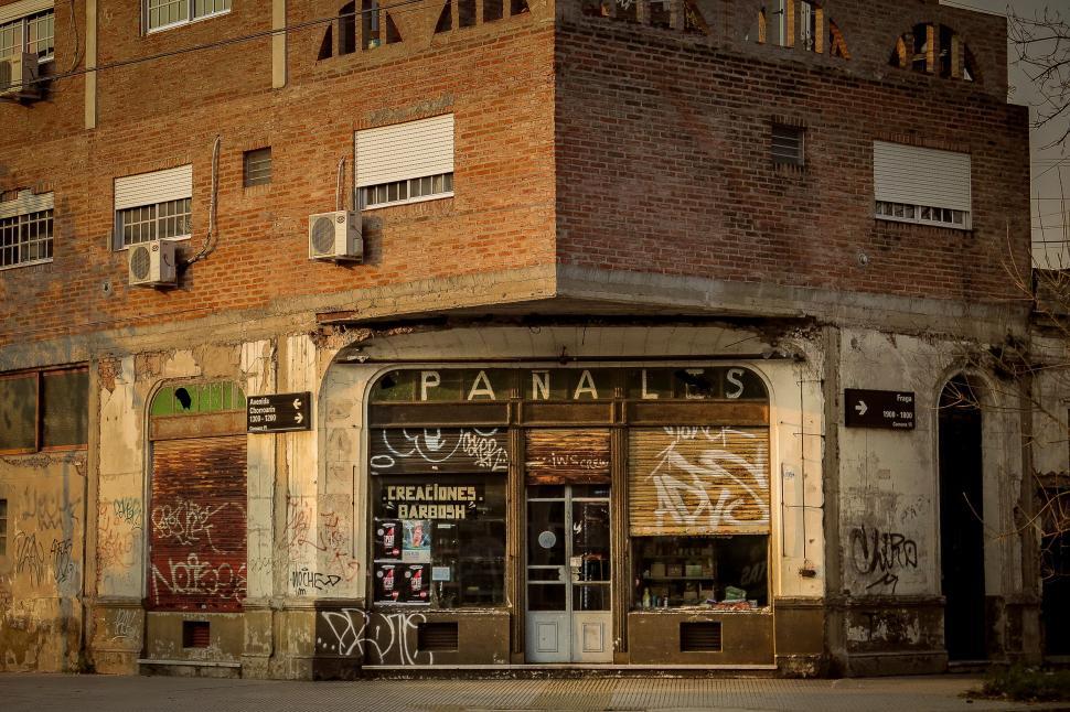 Free Image of Decaying storefront with graffiti tags 