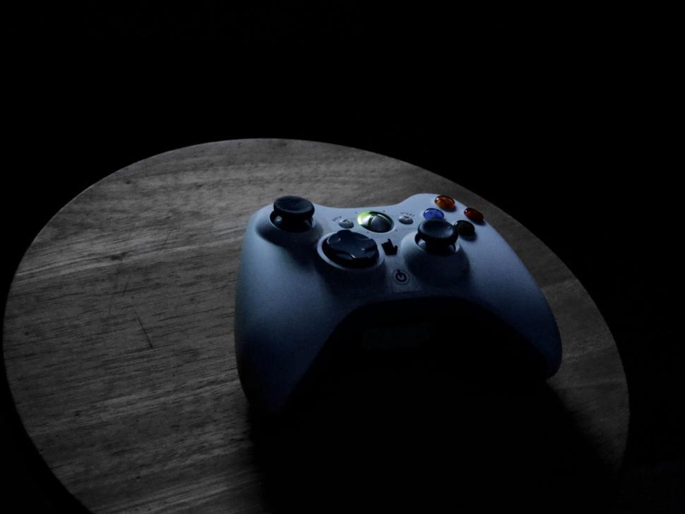 Free Image of Glowing Xbox controller on dark background 