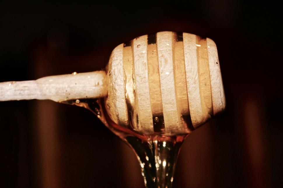 Free Image of Honey drips from wooden dipper 