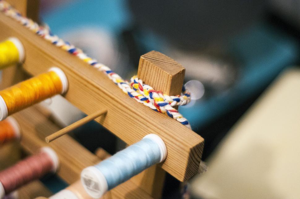 Free Image of Colorful thread on a wooden loom 