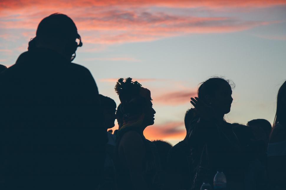 Free Image of Silhouetted figures against sunset sky 