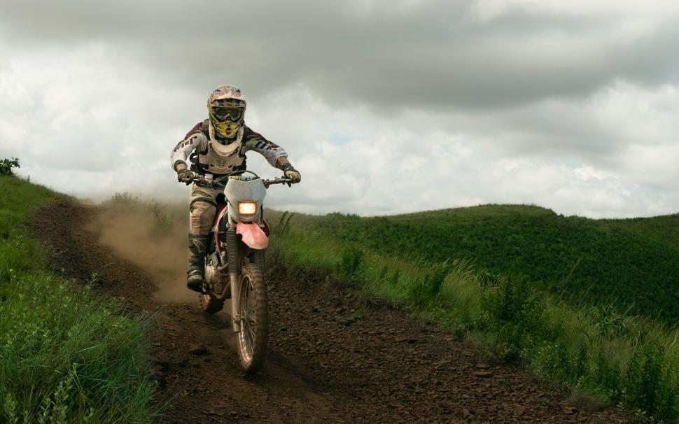 Free Image of Dirt biker racing on rural track 