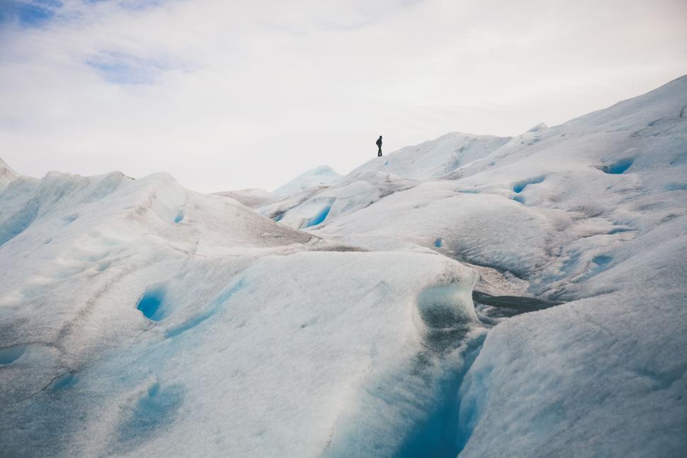 Free Image of Lonely figure on vast glacial landscape 