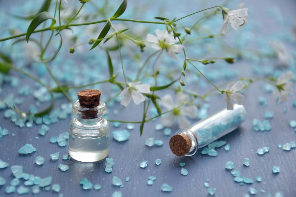 Free Image of Elegant small bottles with flowers and bath salts 