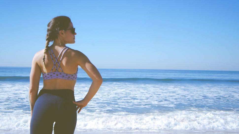 Free Image of Woman gazing at the ocean for a peaceful mood 