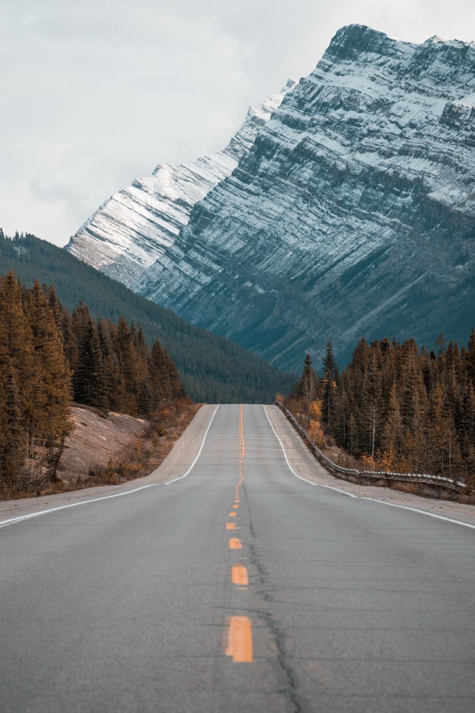 Free Image of Mountainous Road Leading Into Snow-Capped Peaks 